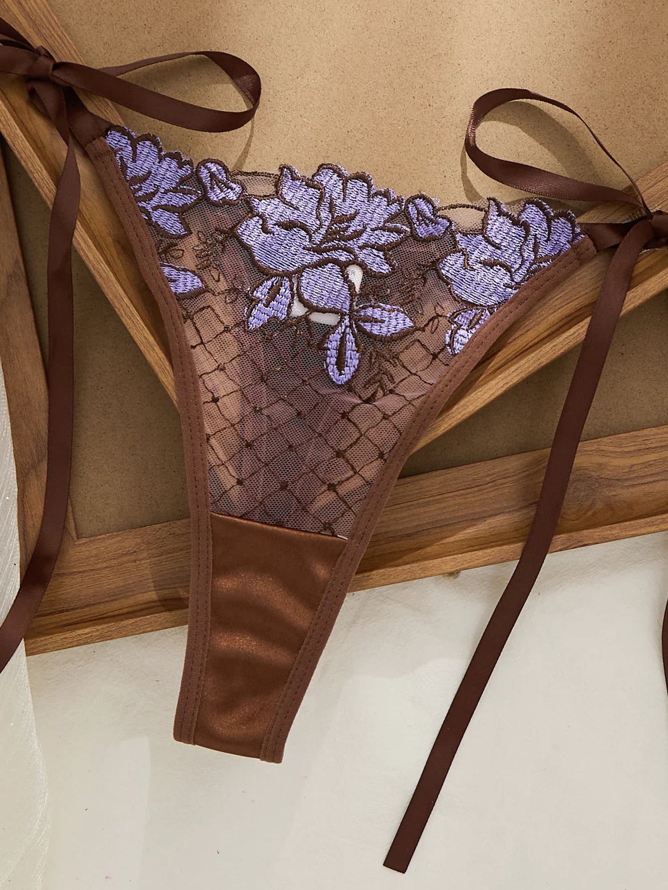 A limited edition brown and purple lace lingerie set with rose embroidery, see-through netting bra, and tie-up thong ZA825200