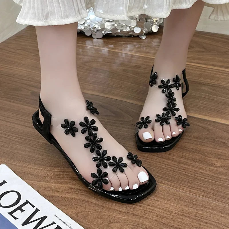 A pair of women's square-toe flat sandals, stylish silver sandals adorned with floral decorations 2026
