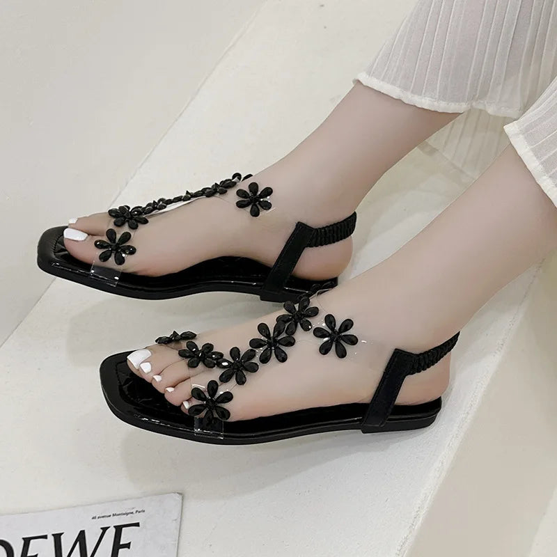 A pair of women's square-toe flat sandals, stylish silver sandals adorned with floral decorations 2026
