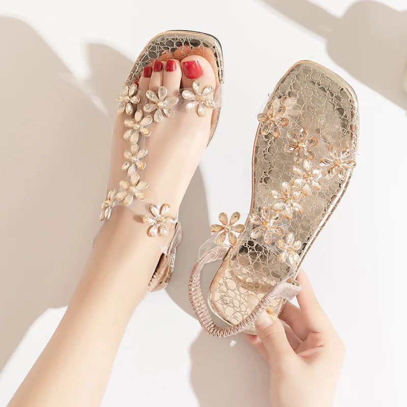 A pair of women's square-toe flat sandals, stylish silver sandals adorned with floral decorations 2026