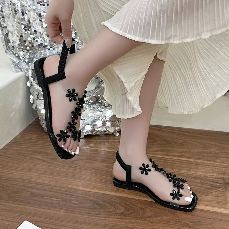 A pair of women's square-toe flat sandals, stylish silver sandals adorned with floral decorations 2026