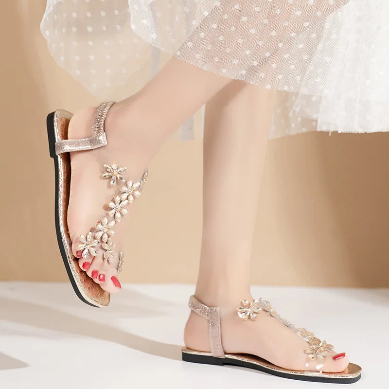 A pair of women's square-toe flat sandals, stylish silver sandals adorned with floral decorations 2026