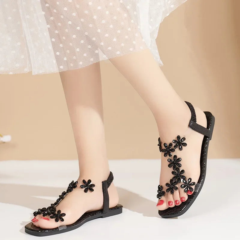 A pair of women's square-toe flat sandals, stylish silver sandals adorned with floral decorations 2026