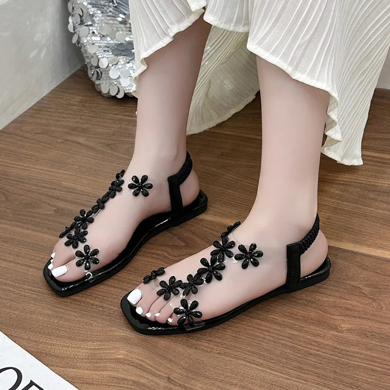 A pair of women's square-toe flat sandals, stylish silver sandals adorned with floral decorations 2026