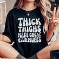 Body Confidence Quote Top – "Thick Thighs Make Great Earmuffs" Graphic T-Shirt